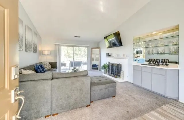 a living room with furniture a flat screen tv and a fireplace