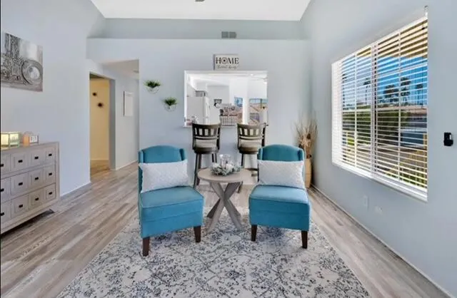 a living room with furniture and wooden floor