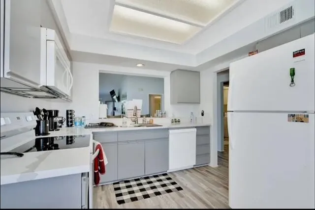 a kitchen with a sink a refrigerator and cabinets