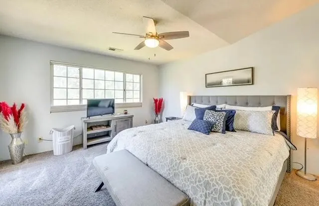 a bedroom with a bed dresser and a window