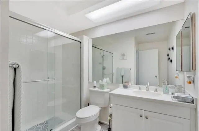 a bathroom with a sink mirror toilet and shower