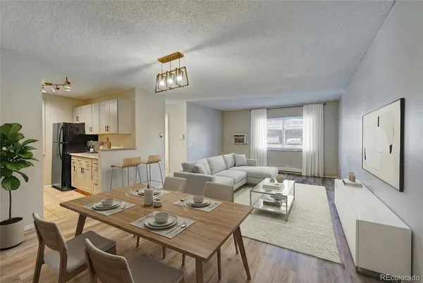 a living room with furniture and kitchen view