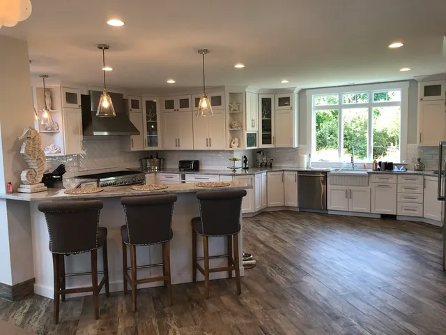 a large kitchen with a table and chairs in it