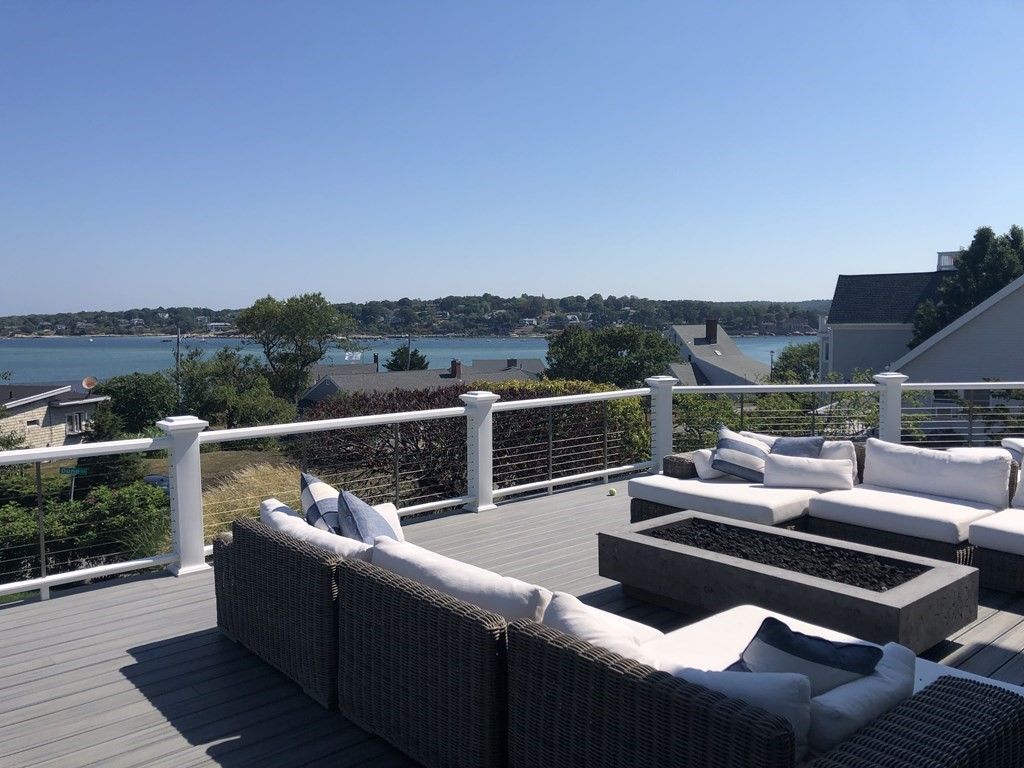 15 Wyoma Road Gloucester, MA 01930 - Photo 7 of 11 a view of a roof deck with couches and sky view