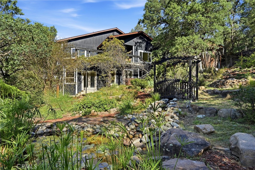 19345 Moon Ridge Road Hidden Valley Lake, CA 95467 - Photo 18 of 64 a view of a house with a tree in the background