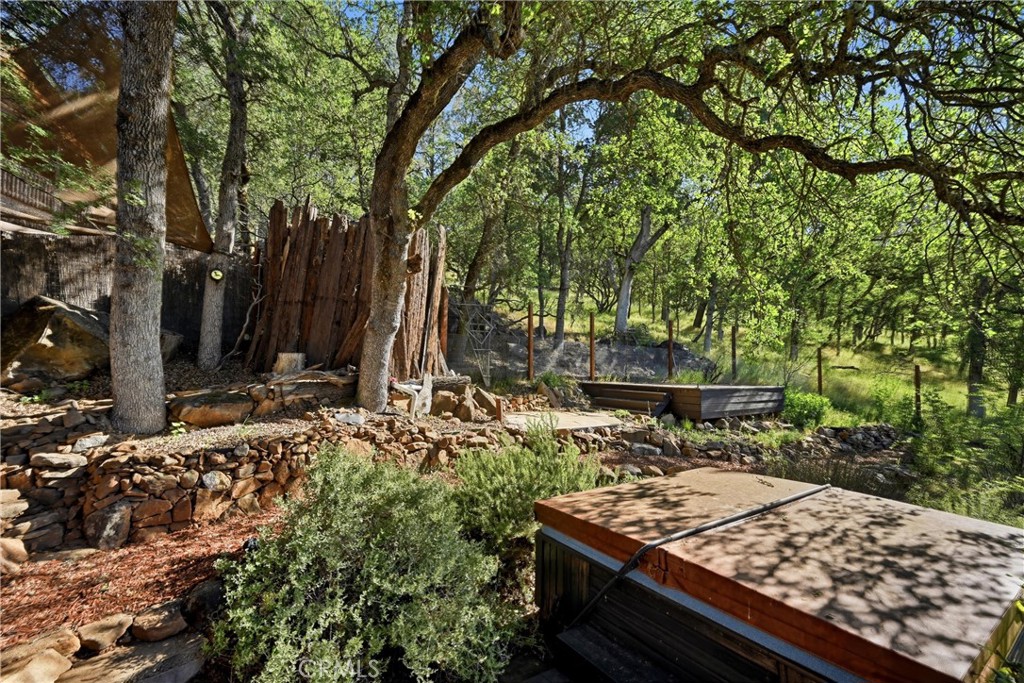 19345 Moon Ridge Road Hidden Valley Lake, CA 95467 - Photo 26 of 64 a view of a backyard with large trees