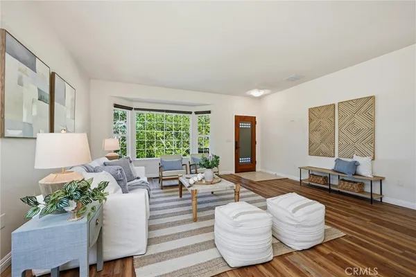 a room with wooden floor and large window