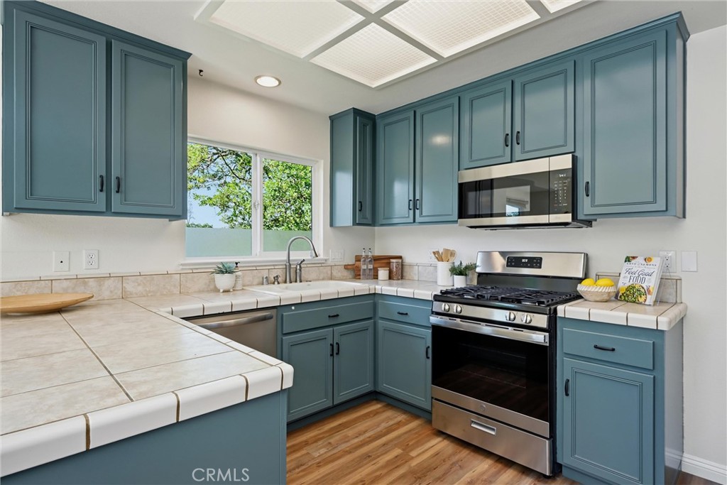 19345 Moon Ridge Road Hidden Valley Lake, CA 95467 - Photo 39 of 64 a kitchen with a sink stove top oven and cabinets