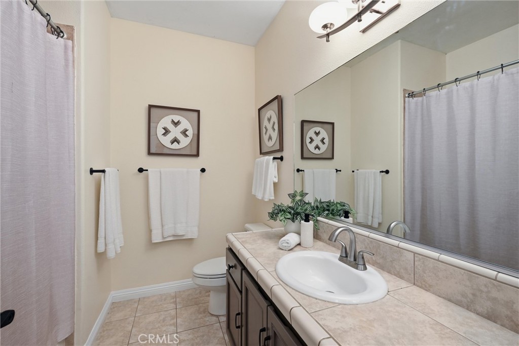 19345 Moon Ridge Road Hidden Valley Lake, CA 95467 - Photo 47 of 64 a bathroom with a granite countertop sink and a mirror
