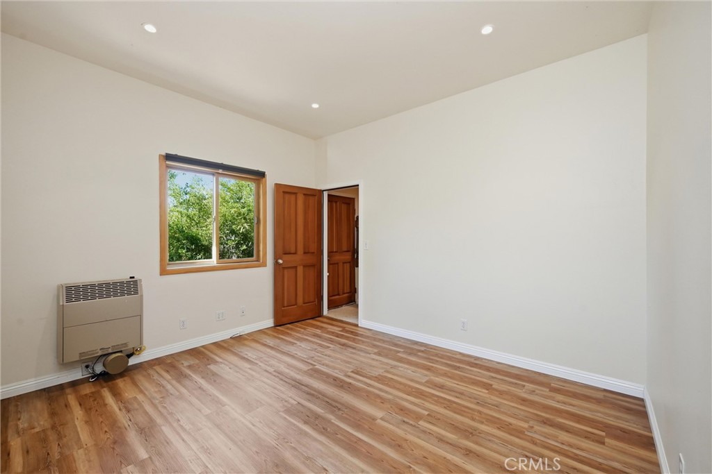 19345 Moon Ridge Road Hidden Valley Lake, CA 95467 - Photo 60 of 64 an empty room with wooden floor and windows