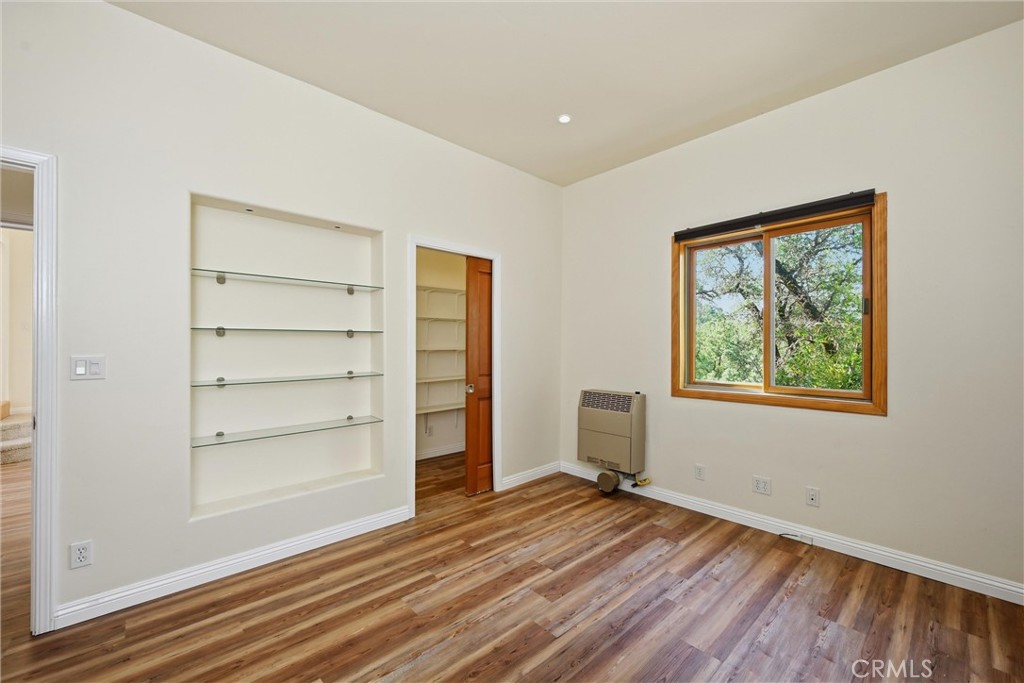 19345 Moon Ridge Road Hidden Valley Lake, CA 95467 - Photo 62 of 64 a view of room with window and wooden floor