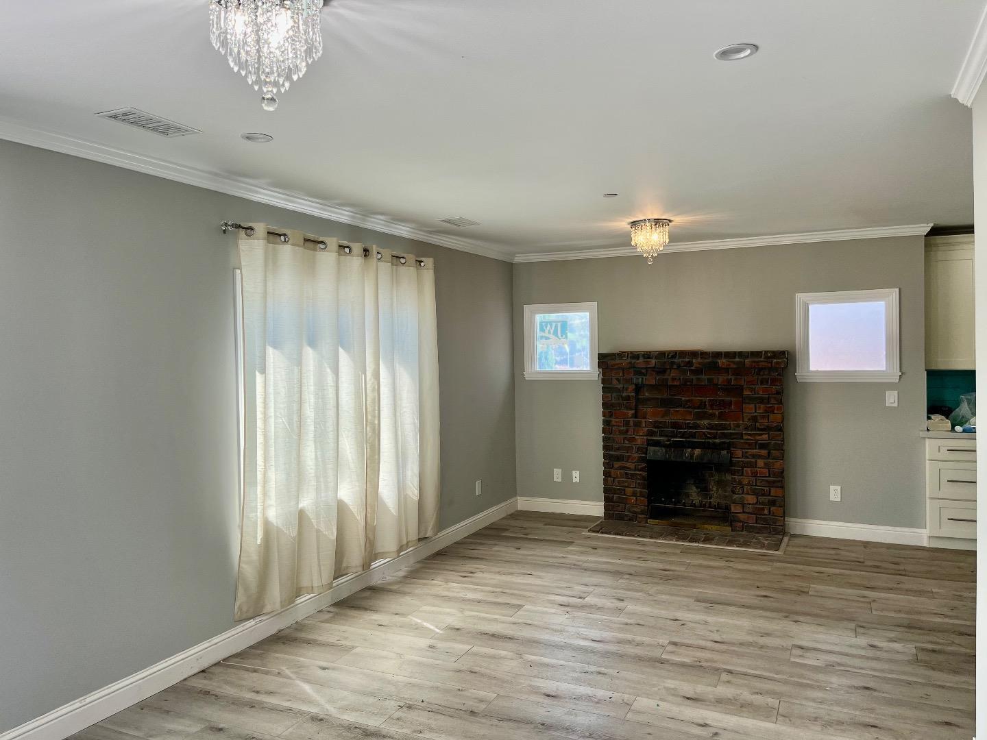 1073 Eighth Street Monterey, CA 93940 - Photo 3 of 11 a view of empty room with wooden floor and fan