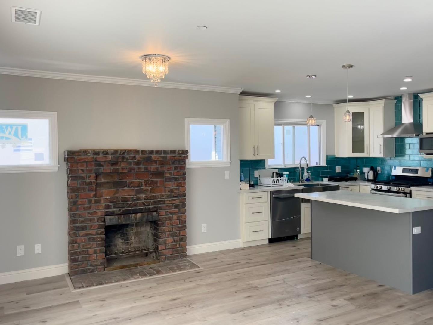 1073 Eighth Street Monterey, CA 93940 - Photo 4 of 11 a kitchen with a refrigerator and a stove top oven