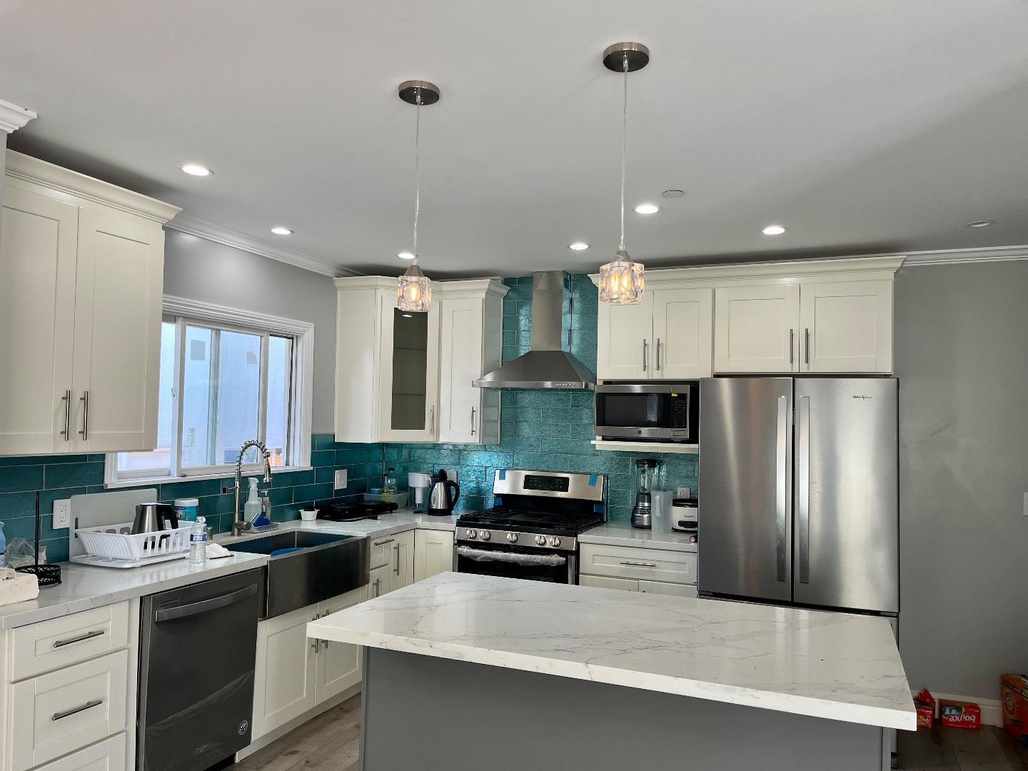 1073 Eighth Street Monterey, CA 93940 - Photo 5 of 11 a kitchen with stainless steel appliances granite countertop a refrigerator a sink dishwasher a stove and white cabinets with wooden floor