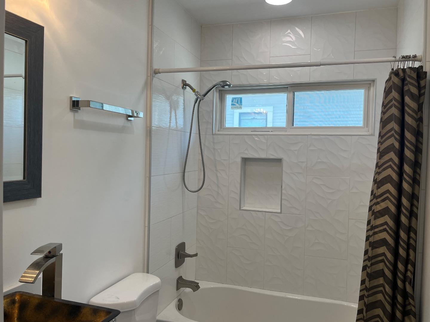 1073 Eighth Street Monterey, CA 93940 - Photo 6 of 11 a bathroom with a shower and a toilet