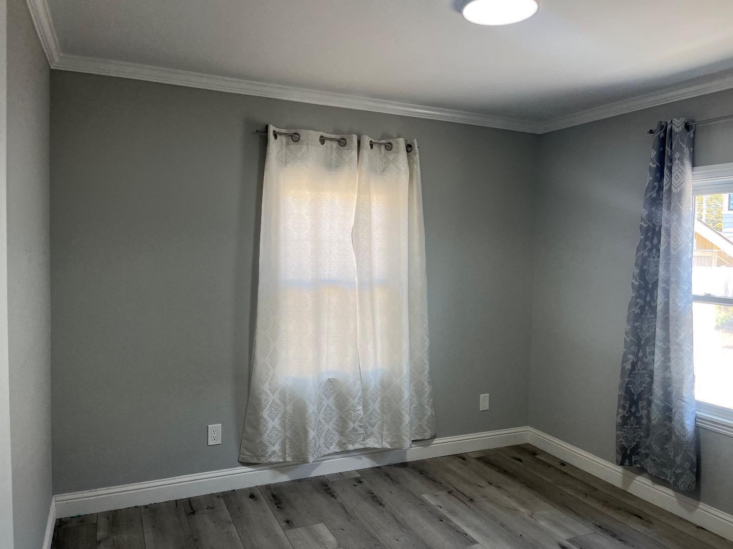1073 Eighth Street Monterey, CA 93940 - Photo 10 of 11 a view of an empty room with wooden floor and a window