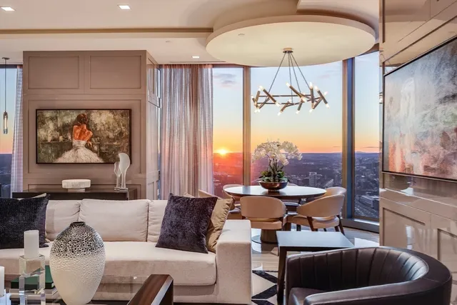 a living room with furniture a chandelier and a painting