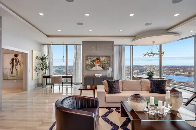 a living room with fireplace furniture and a large window