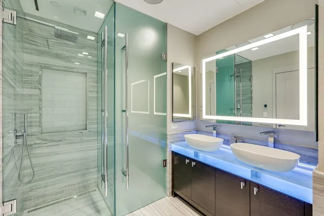 a bathroom with a granite countertop sink shower and a mirror