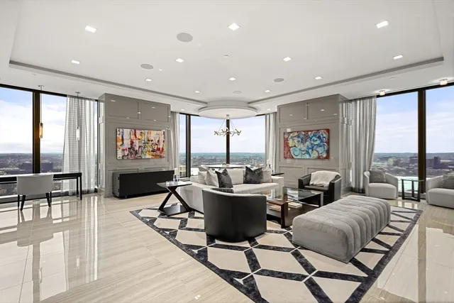 a living room with furniture and a floor to ceiling window