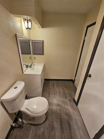 a white toilet sitting next to a bathroom sink