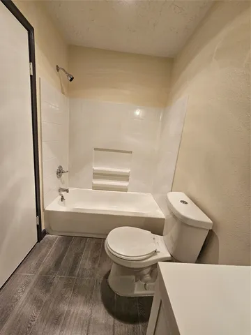 a bathroom with a toilet and a bathtub