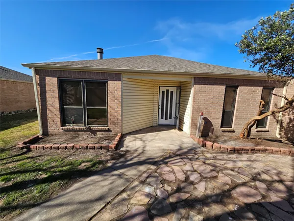 a view of front door and a yard
