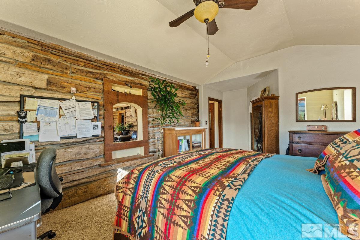 10977 Austin Road Austin, NV 89310 - Photo 11 of 40 a bedroom with a bed a dresser next to a window