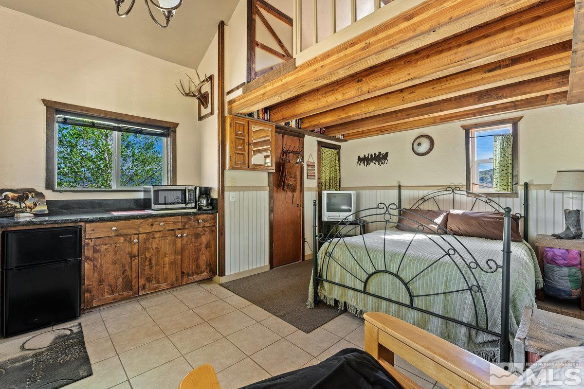 10977 Austin Road Austin, NV 89310 - Photo 25 of 40 a bedroom with furniture and a large window