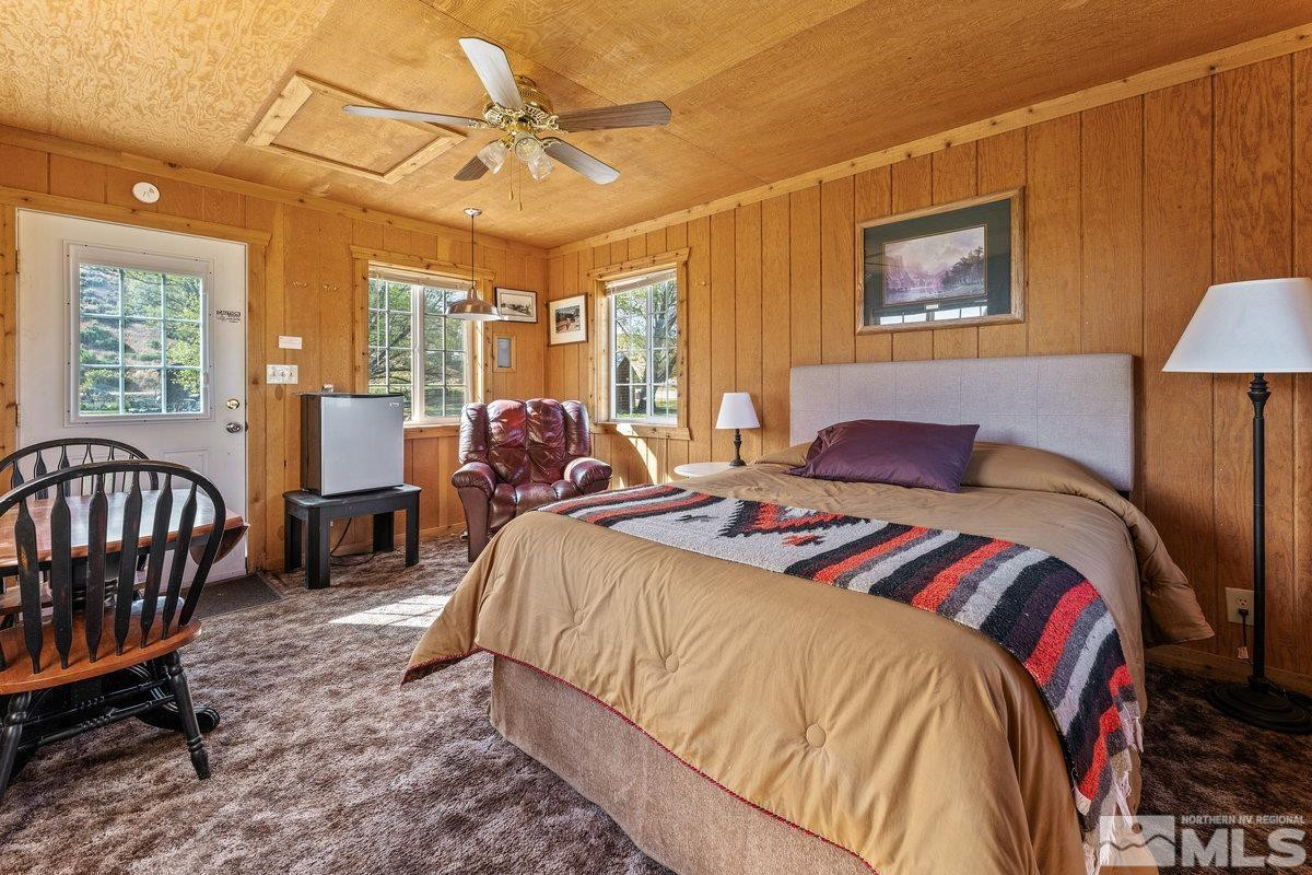 10977 Austin Road Austin, NV 89310 - Photo 26 of 40 a bedroom with a bed and a chandelier