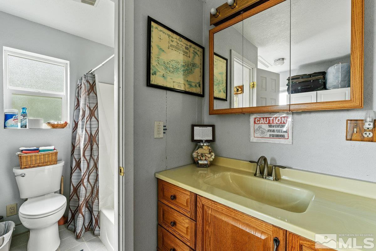 10977 Austin Road Austin, NV 89310 - Photo 28 of 40 a bathroom with a sink a toilet and shower