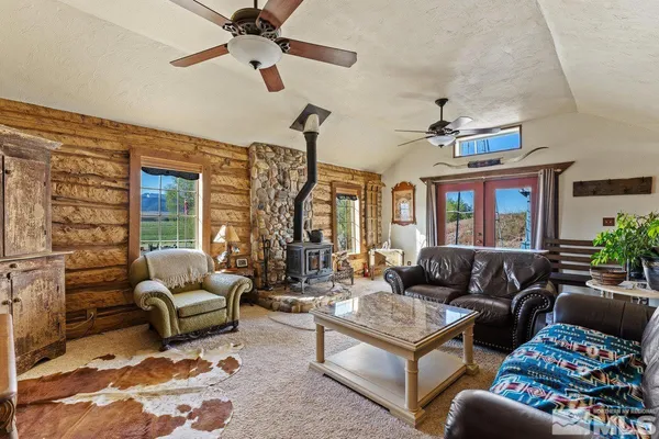 a living room with furniture ceiling fan and a window