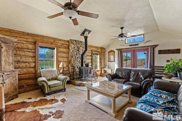 a living room with furniture ceiling fan and a window