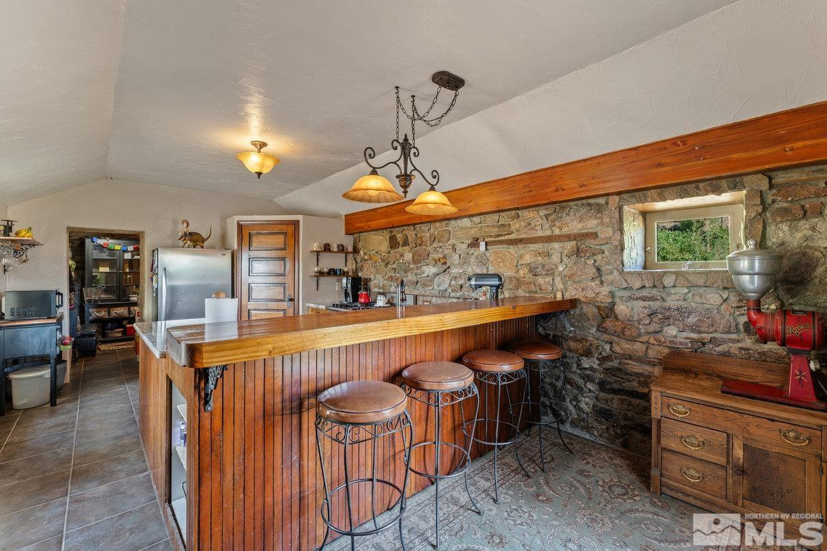 10977 Austin Road Austin, NV 89310 - Photo 6 of 40 a dining hall with stainless steel appliances granite countertop a sink a stove and a wooden floors