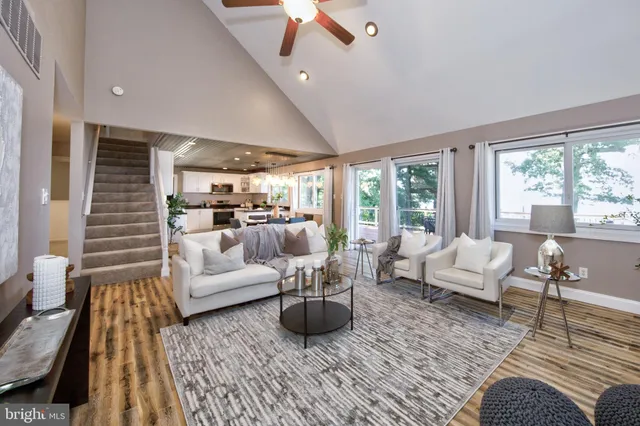 an empty room with a window and a ceiling fan