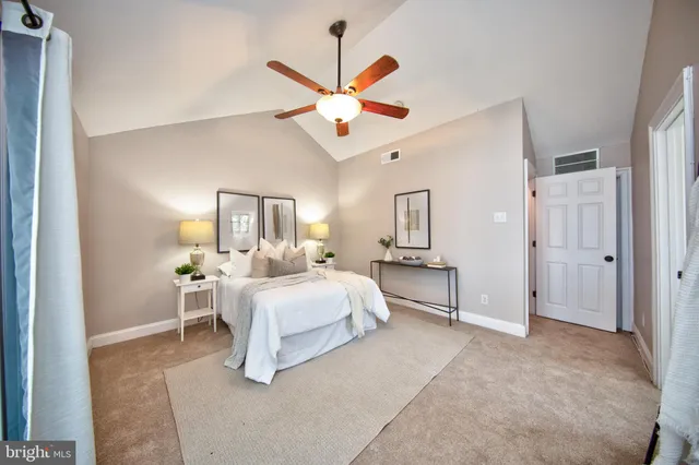 a bathroom with a granite countertop sink mirror and a toilet