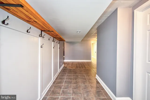 a view of empty room with wooden floor and fireplace