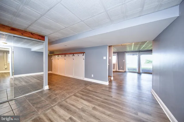 a view of a roof deck with table and chairs a barbeque with wooden floor and fence