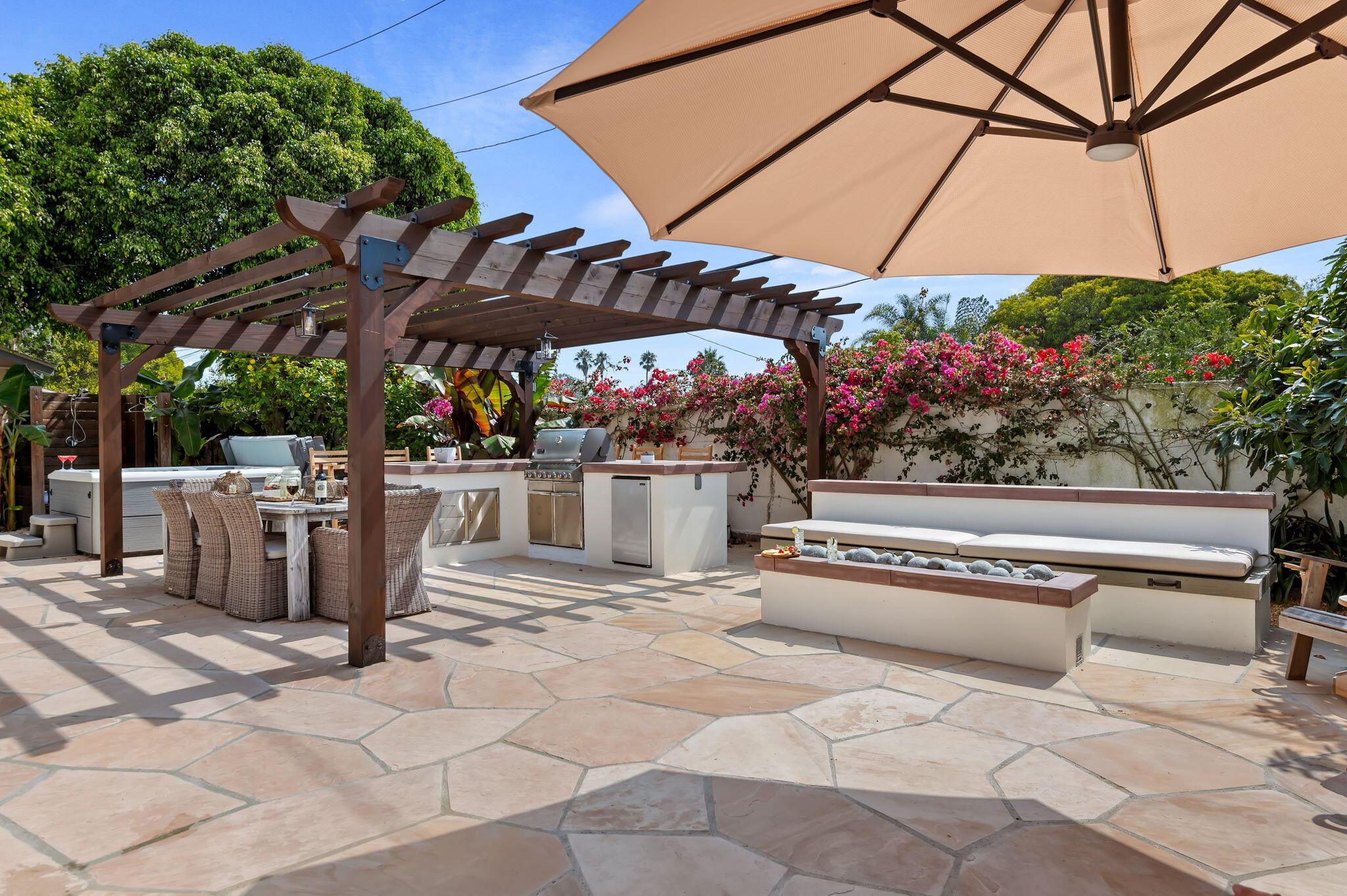 Undisclosed Address Santa Barbara, CA 93109 - Photo 12 of 28 a view of a patio with a table and chairs under an umbrella
