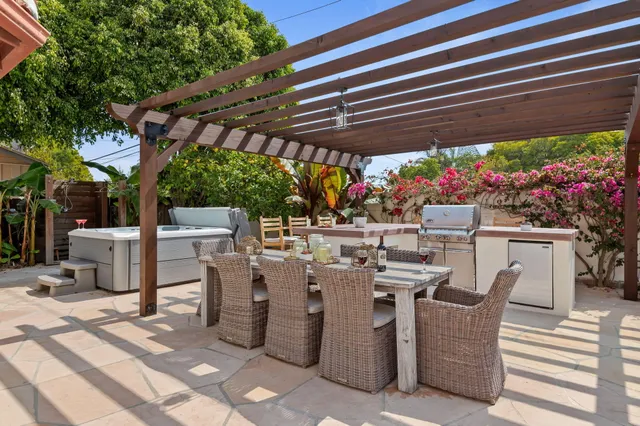a view of a patio with table and chairs potted plants