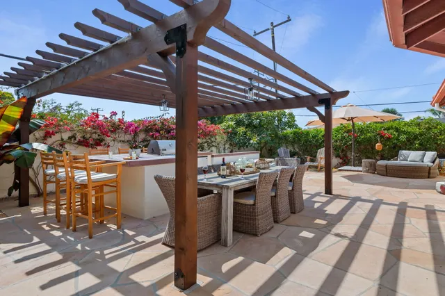 a view of a patio with a table and chairs