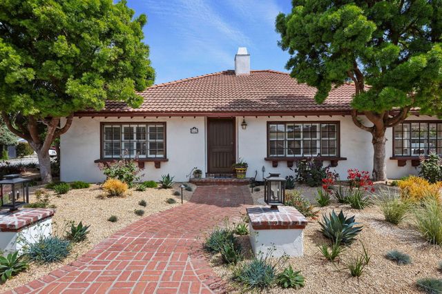 a front view of a house with a sitting area