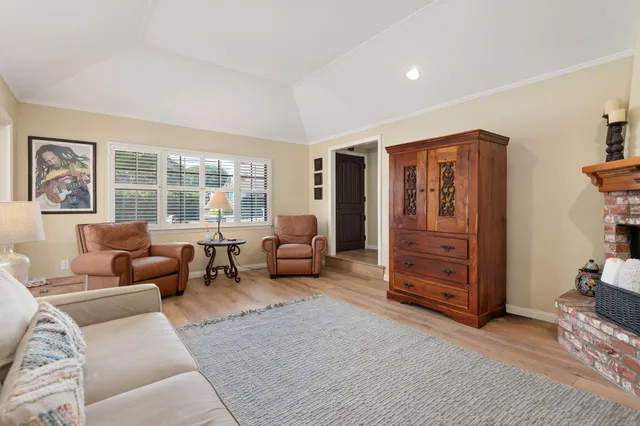 a living room with furniture and large windows