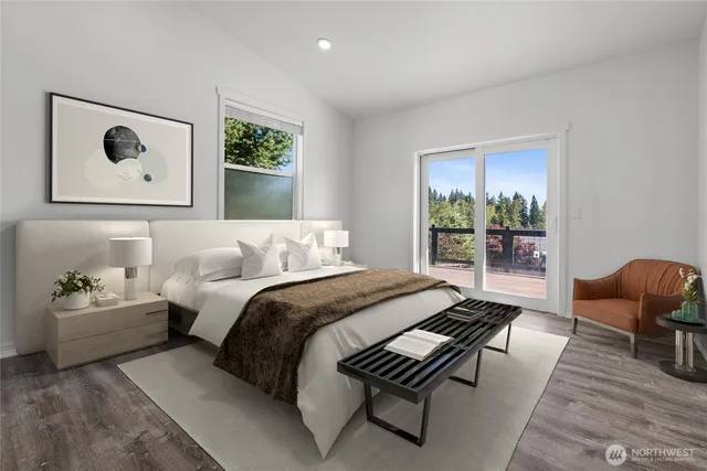 a bedroom with bed couch and window