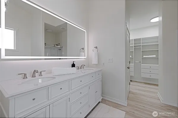 a bathroom with a bathtub a sink and a mirror