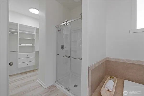 a view of empty room with wooden floor and potted plant