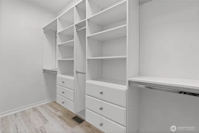 a room with white cabinets and closet