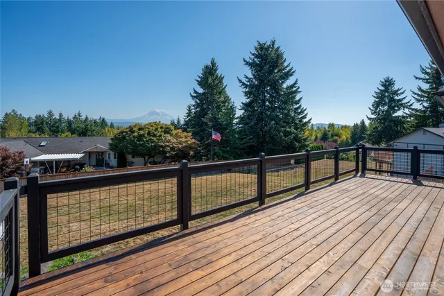 a view of a balcony with wooden floor and outdoor seating
