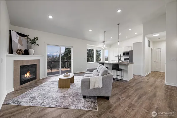 a kitchen with kitchen island granite countertop a sink stainless steel appliances and cabinets