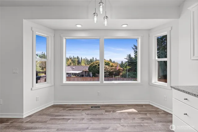 an empty room with windows and closet